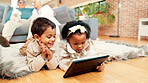 Children, kids and watching with tablet on floor for entertainment, interaction or online streaming. Siblings, lying or technology with smile or network for show, movie or cartoon together in house