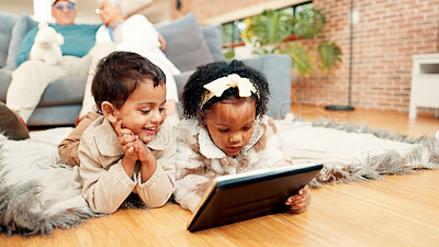 Buy stock photo Happy, kids and watching with tablet on floor for entertainment, or online streaming in home. Siblings, lying or children with technology or grandparents for show, movie or cartoon together in house