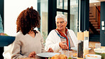 Family dinner, senior woman and talking in home for social gathering, holiday celebration or support. Love, people and old person with lunch party at dining table for festive reunion, bonding or chat