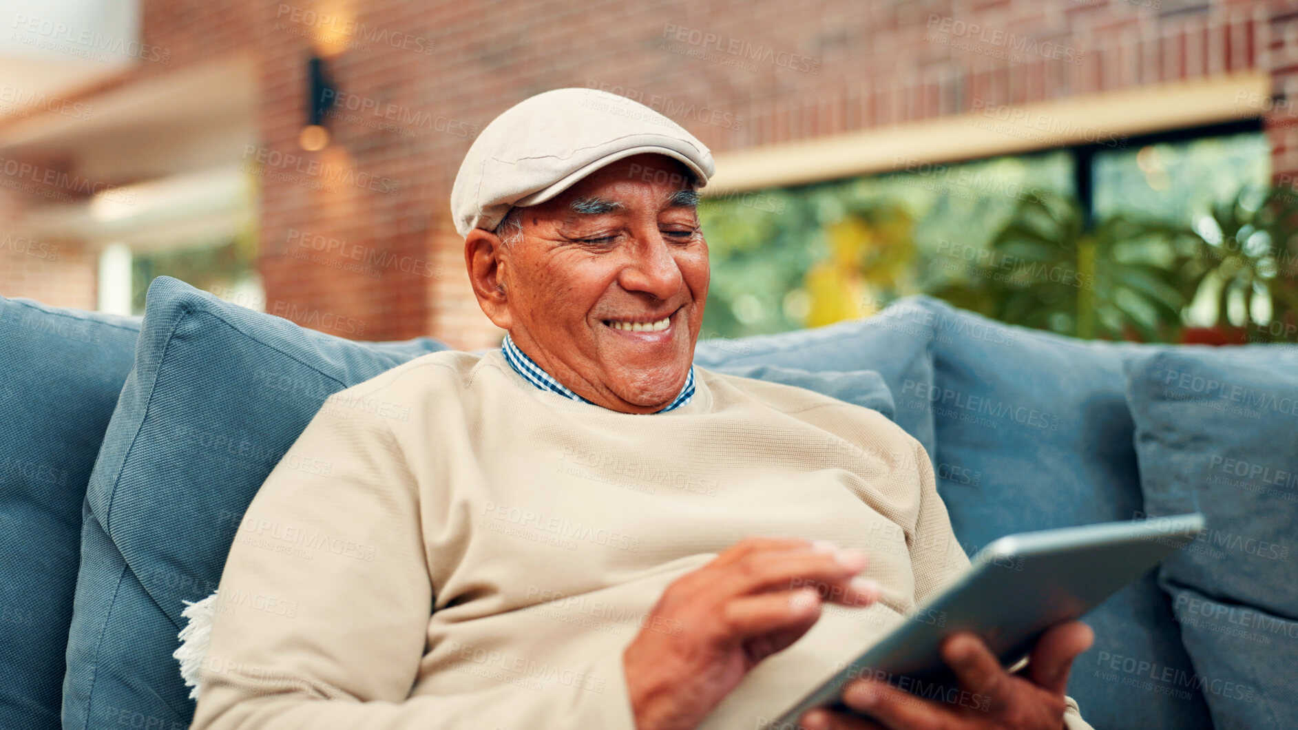 Buy stock photo Tablet, happy and senior man on sofa in home with networking, social media or blog post. Relax, digital technology and elderly male person in living room for reading news headline on app in house.