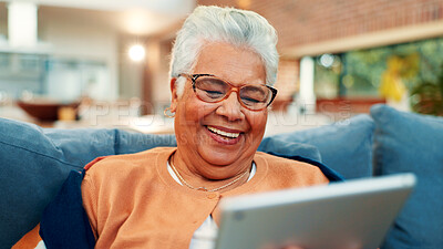 Buy stock photo Tablet, happy and senior woman on sofa in home with networking, social media or blog post. Relax, digital technology and elderly female person in living room for reading news headline in house.