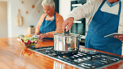 Buy stock photo Pot, hand and man with couple cooking together in home, check supper and tablet for online tutorial. Person, old woman and meal prep with tech for food blog, healthy snack or dinner in retirement