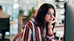 Business woman, bored and reading at computer for copywriting research, low energy or tired at office. Serious, fatigue or burnout with employee in coworking workplace, tech and media report deadline