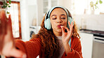 Woman, influencer and kiss with headphones for selfie, photography or profile picture in home. POV, female person or vlogger with smile, emoji and online streaming for content creation in house