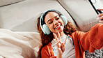 Woman, influencer and peace sign with headphones for selfie, photography or profile picture in home. Tech, person or vlogger with smile, emoji and streaming for content creation in house living room