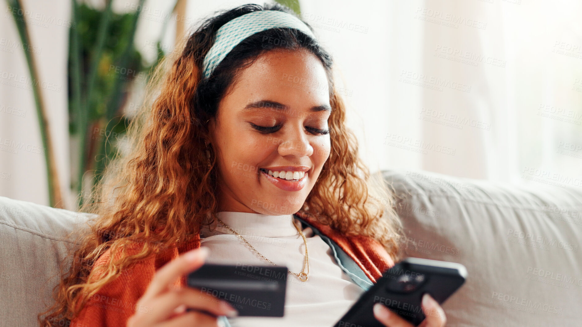 Buy stock photo Credit card, phone and smile with student on sofa for online shopping, ecommerce and loan. Digital payment, banking website and woman in living room of home for fintech, transaction or subscription