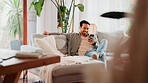 Smile, cellphone and man relax in living room for online news, social media profile and post. Mobile, reading and happy person in home for communication with contact, email or watch video on internet