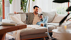 Laugh, cellphone and man relax in living room for online meme, social media post and gif. Mobile, reading and happy person in home for communication with contact, joke and funny video on internet