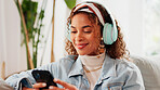 Relax, woman or phone with headphones on sofa for social media video, music album or weekend break. Smile, person and smartphone in home for listening to podcast, sound playlist and streaming service