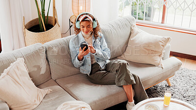 Buy stock photo Relax, woman or phone with headphones in home for music search, streaming podcast or weekend break. Above, person and smartphone on sofa for listening to radio, sound playlist and social media video