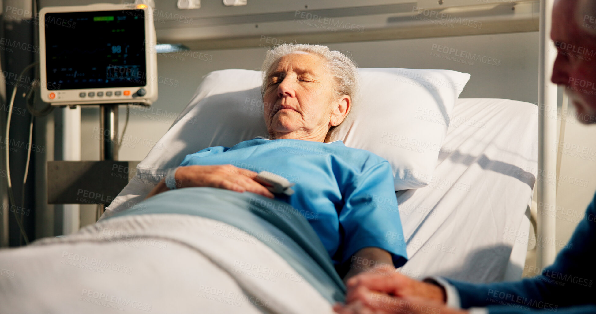 Buy stock photo Holding hands, hospital bed and senior woman with man for support, rest and comfort for recovery. Healthcare, marriage and sick elderly patient with husband for empathy and wellness in clinic