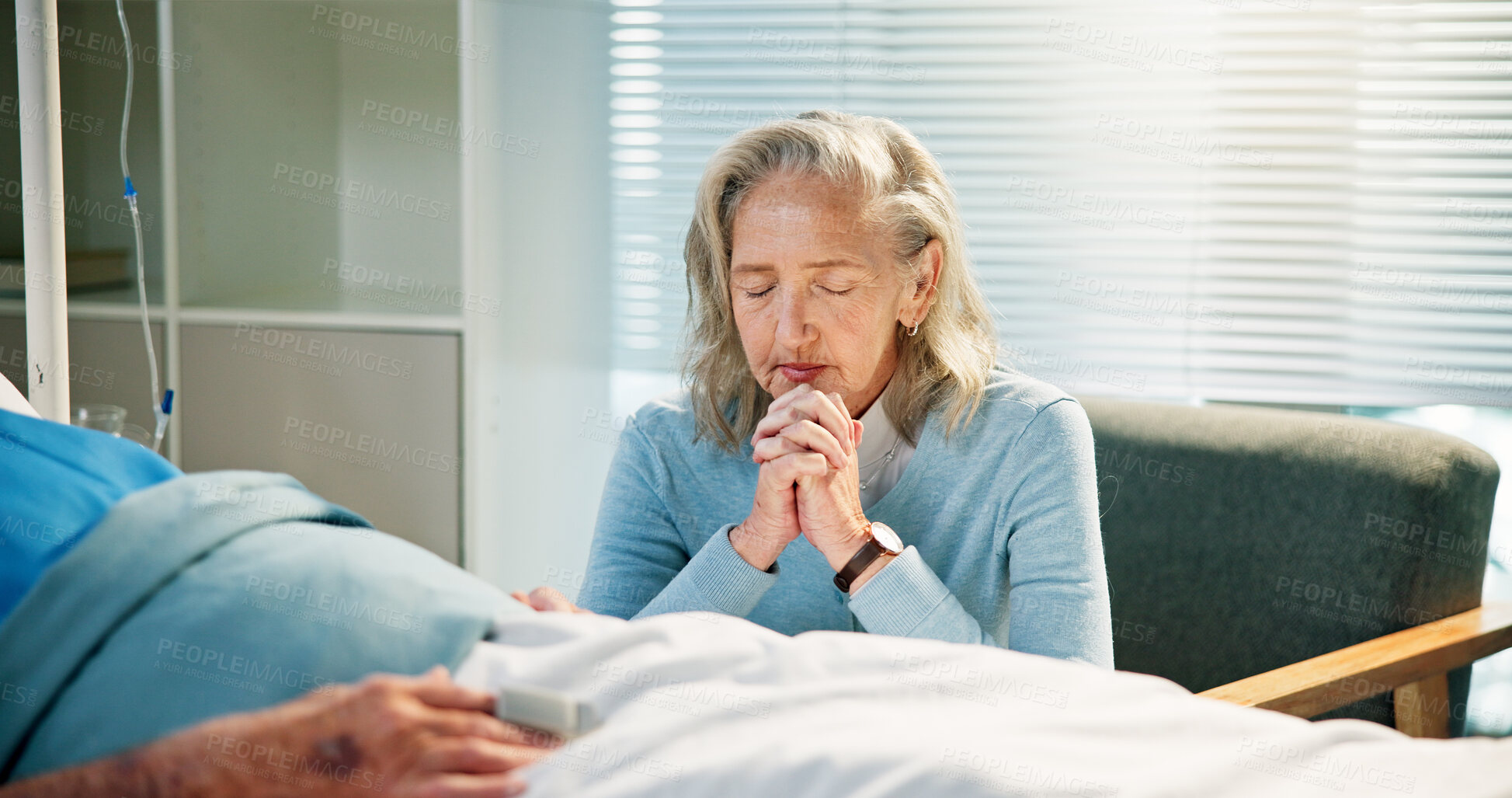 Buy stock photo Senior patient, wife and praying at hospital bed for health recovery, terminal illness and belief. Healthcare, old couple and sick man with worship in clinic for surgery procedure, healing and faith