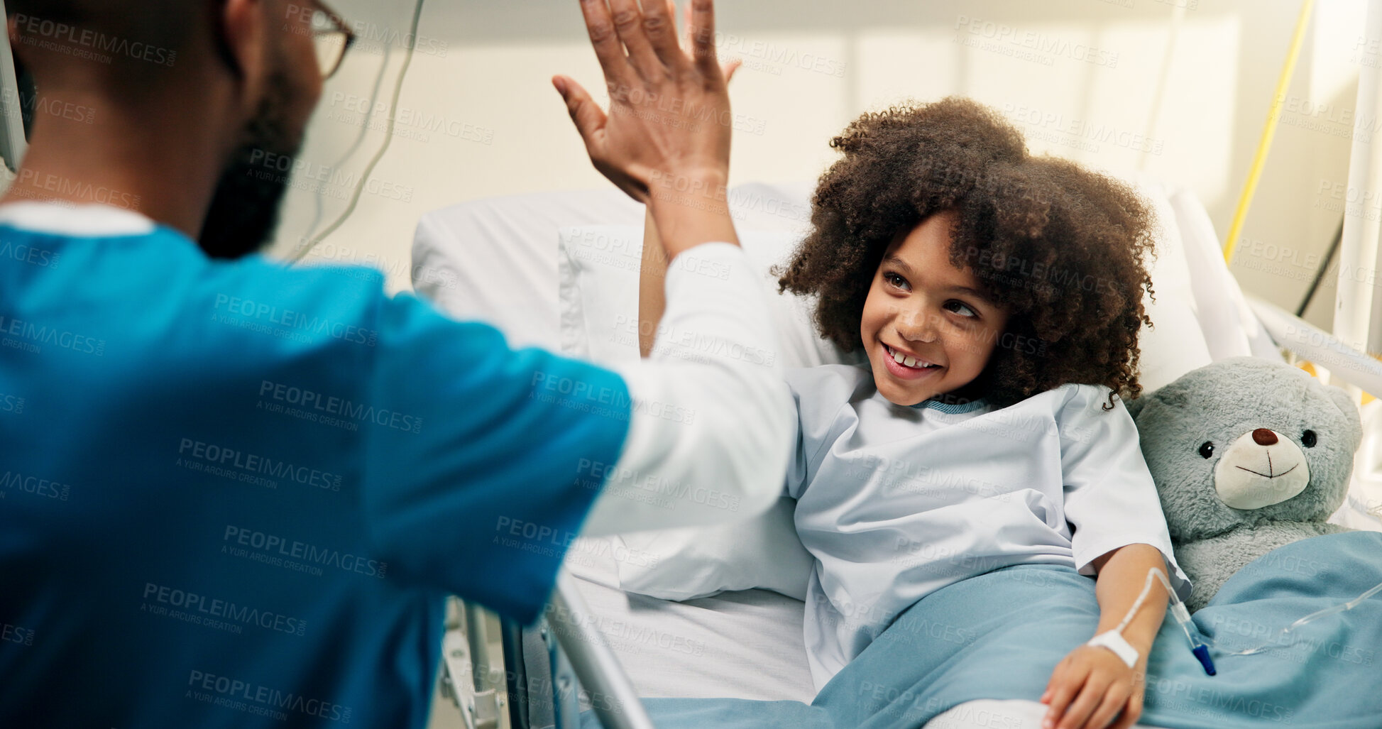 Buy stock photo Boy, doctor and high five with smile in hospital bed, happy and care with support for recovery. Pediatrician, child and excited with teddy bear, motivation and celebration with healing at clinic