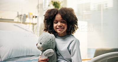 Buy stock photo Healthcare, child or smile with teddy bear on hospital bed for surgery recovery, checkup or wellness. African kid, patient or portrait with toy in clinic for pediatrics appointment or healthy healing