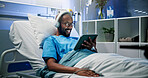 Black man, headphones and rest with tablet in hospital bed for streaming music, movies and recovery. Male person, inpatient and digital for listening to audio, watching film and healing of operation
