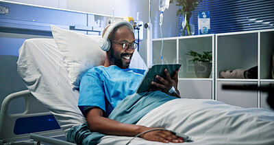 Buy stock photo Black man, headphones and rest with tablet in hospital bed for streaming music, movies and recovery. Male person, inpatient and digital for listening to audio, watching film and healing of operation