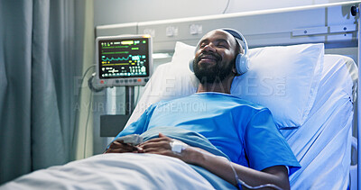 Buy stock photo Black man, rest and sleeping with headphones in hospital bed for streaming music, podcast and recovery. Male person, inpatient and listening to audio of playlist, album and healing nap from operation