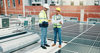 Buy stock photo Solar panels, team or engineer on rooftop with blueprint, construction or maintenance planning. Collaboration, photovoltaic grid or people check for electricity production, clean energy or renovation