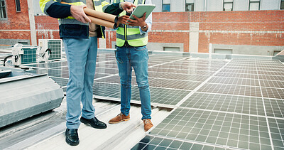 Buy stock photo Solar panels, legs or people on rooftop with tablet for maintenance check, construction or teamwork. Collaboration, photovoltaic grid or technician with tech, review power production or clean energy