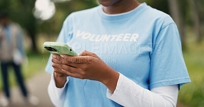 Buy stock photo Hands, phone and volunteer with woman outdoor for charity, community outreach or food drive. App, text message and typing with person in park for activism, ngo donation or non profit communication