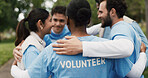 Volunteer, group in circle or huddle outdoor for community service, NGO and help for social responsibility. Back support, team and people with motivation for nonprofit charity and activism in park 