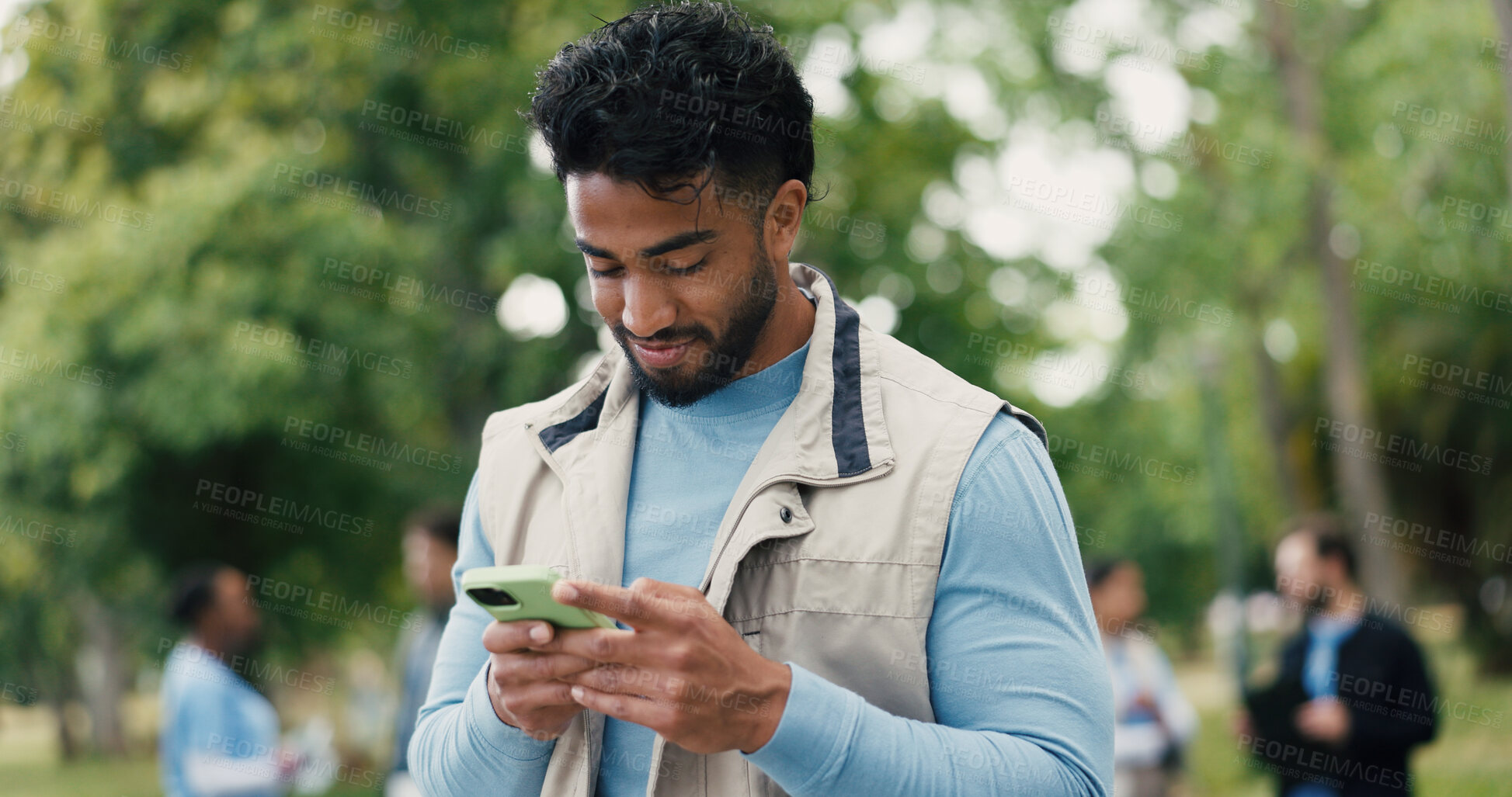 Buy stock photo Agenda, phone and volunteer with man in park for charity, community outreach or food drive. App, schedule and typing with happy person outdoor for activism, donation or non profit communication