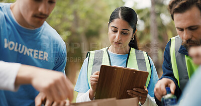 Buy stock photo Clipboard, volunteer or people with paper bag in park, community service or packaging for charity drive. Teamwork, non profit or woman with donation list for food security crisis, supplies or outdoor