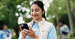 Cellphone, woman and volunteer in nature for networking, contact or social media post for outreach. Happy, outdoor and female ngo worker with phone for communication with community service in park.