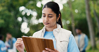 Buy stock photo Clipboard, volunteer and writing with woman in park for donation, community service and ngo project. Nonprofit checklist, grocery distribution and food drive with person outdoor for outreach program