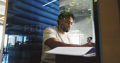 Buy stock photo Writing, thinking and businessman in office with notebook for planning creative project in pod. Booth, professional and magazine editor working on article with research for publishing in workplace.