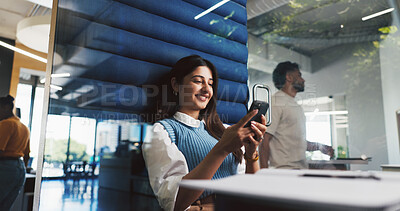 Buy stock photo Phone, pod and text message with designer woman in office for project feedback, post or update. App, communication and typing with design employee in booth for hybrid work, planning or research