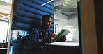 Pod, research and tablet with designer black man in office for project feedback, post or update. App, information and planning with African employee in cubicle of design workplace for development