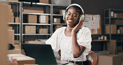 Buy stock photo Small business, woman and laptop with headphones in logistics for inventory, music and shipping. Supply chain, black person and happy with tech for streaming playlist, online order or track delivery