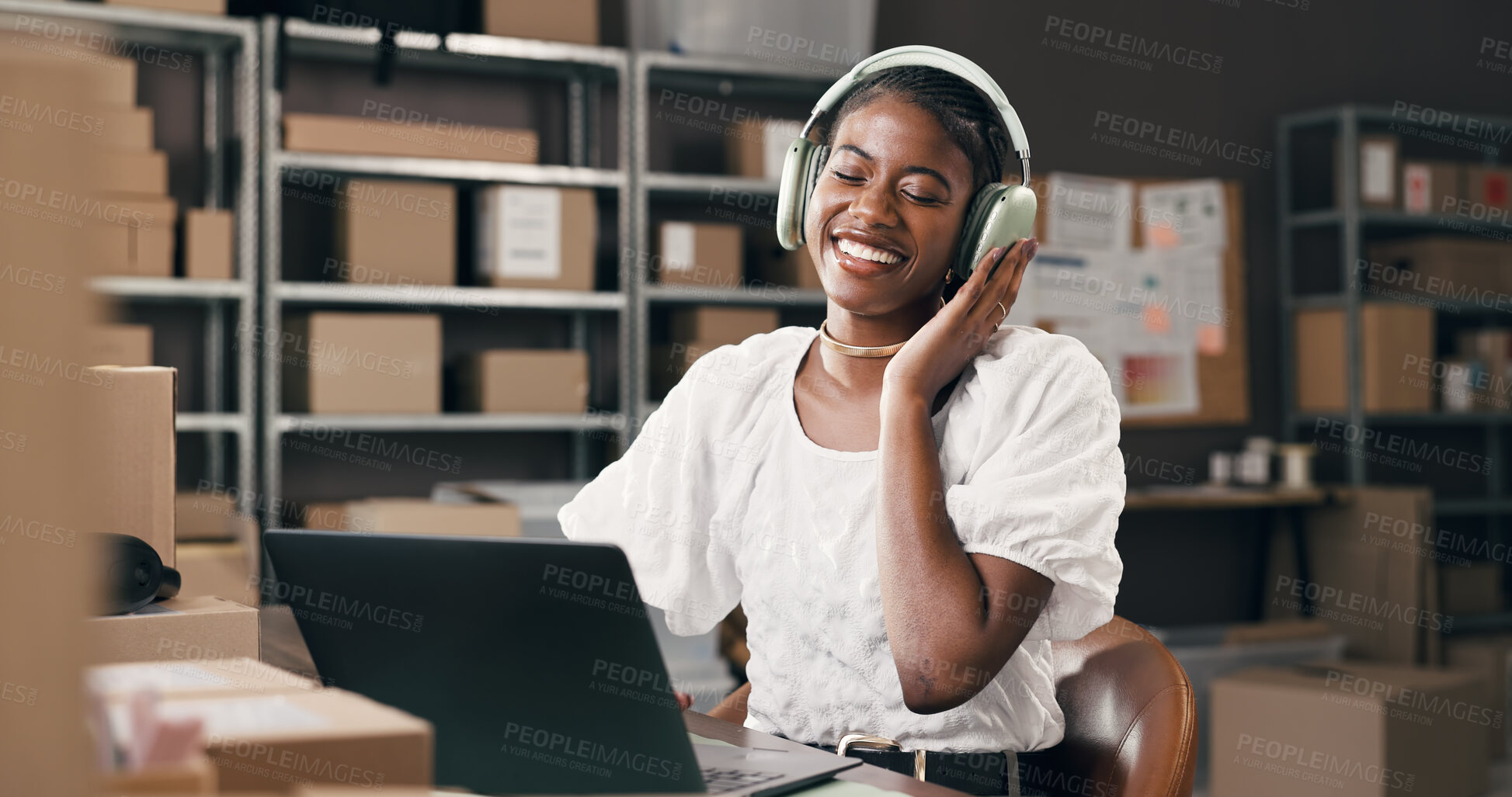 Buy stock photo Small business, woman and laptop with headphones in logistics for inventory, music and shipping. Supply chain, black person and happy with tech for streaming playlist, online order or track delivery