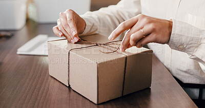 Buy stock photo Hands, box and string at startup for dropshipping, eco friendly packaging and logistics for ecommerce order. Person, cardboard parcel and knot for stock, distribution or shipping at storage plant