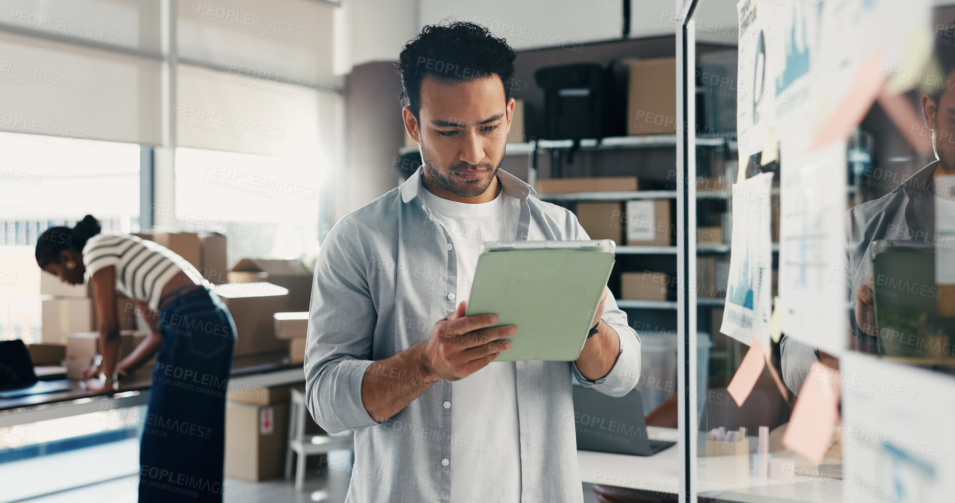 Buy stock photo Glass wall, logistics and man with tablet for planning, ecommerce ideas or analysis. Technology, reading and entrepreneur in startup for distribution strategy, shipping or business graphs in office