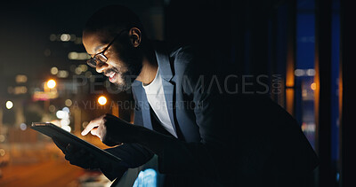 Buy stock photo Black man, tablet and night at office, balcony and smile with typing, review and check notification on break. African person, writer and happy with tech, app or overtime for job at creative agency