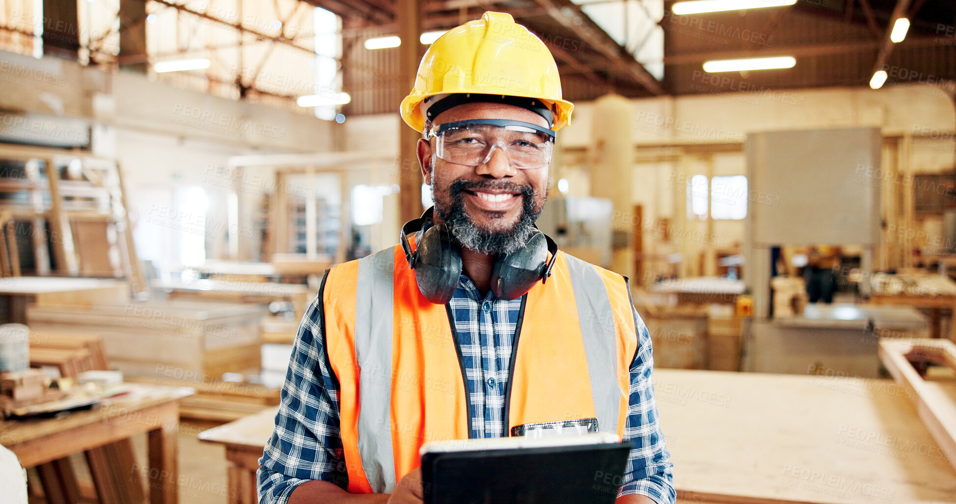 Buy stock photo Man, carpenter and tablet with smile at factory, confident or portrait for furniture manufacturing. Mature person, technician and happy with pride for woodwork, app and helmet for project at workshop
