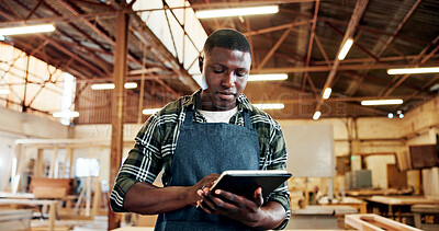 Buy stock photo Carpenter, serious and man with tablet, workshop and plan for furniture production on web or online. Small business, artisan and black person with tech for inventory, manufacturing and craftsmanship