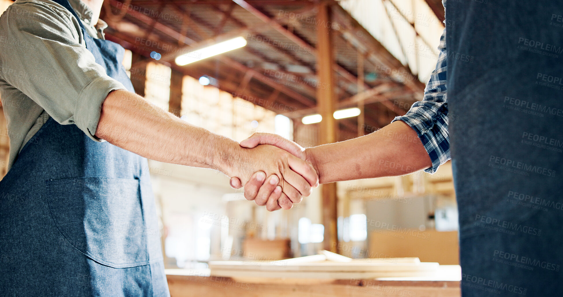Buy stock photo People, carpenter and handshake with deal for agreement, partnership or b2b in workshop. Employees, colleagues or woodworker shaking hands with wood, timber or lumber for DIY project or furniture