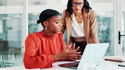 Buy stock photo Conversation, business women and laptop in office for feedback, news report and teamwork. Discussion, creative employees and journalist in meeting for research, advice and article for proofreading