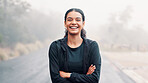 Outdoor, road or portrait of happy woman with arms crossed, marathon runner or ready for cardio training. Fitness, morning mist or confident athlete with endurance practice, wellness or start workout
