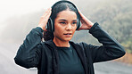 Fitness, rain and woman with headphones outdoor to start running, music playlist and cardio podcast. Athlete, person and ready for exercise in road with audio streaming, wellness workout or raindrops