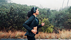 Fitness, woman and running with headphones in road for exercise, music playlist and cardio podcast. Athlete, person and workout in nature with audio streaming, pace training and endurance challenge