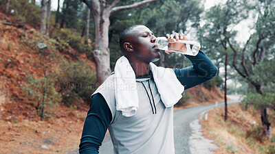 Buy stock photo Fitness, black man and drink water in forest with towel for wellness, workout break and recovery. Active person outdoor, beverage and electrolytes in nature for exercise rest, hydration and thirst.