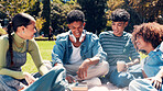 Happy people, students or laughing with book in park for social interaction or funny joke in nature. Group, friends or smile with humor, novel or story for comedy, gathering or bonding on grass field