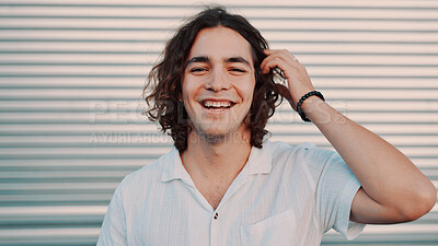 Buy stock photo Portrait, laugh and man in city for travel, vacation and adventure by garage door. Hair, funny and person outdoor with confidence on holiday, tourism and space on trip with happiness in Argentina