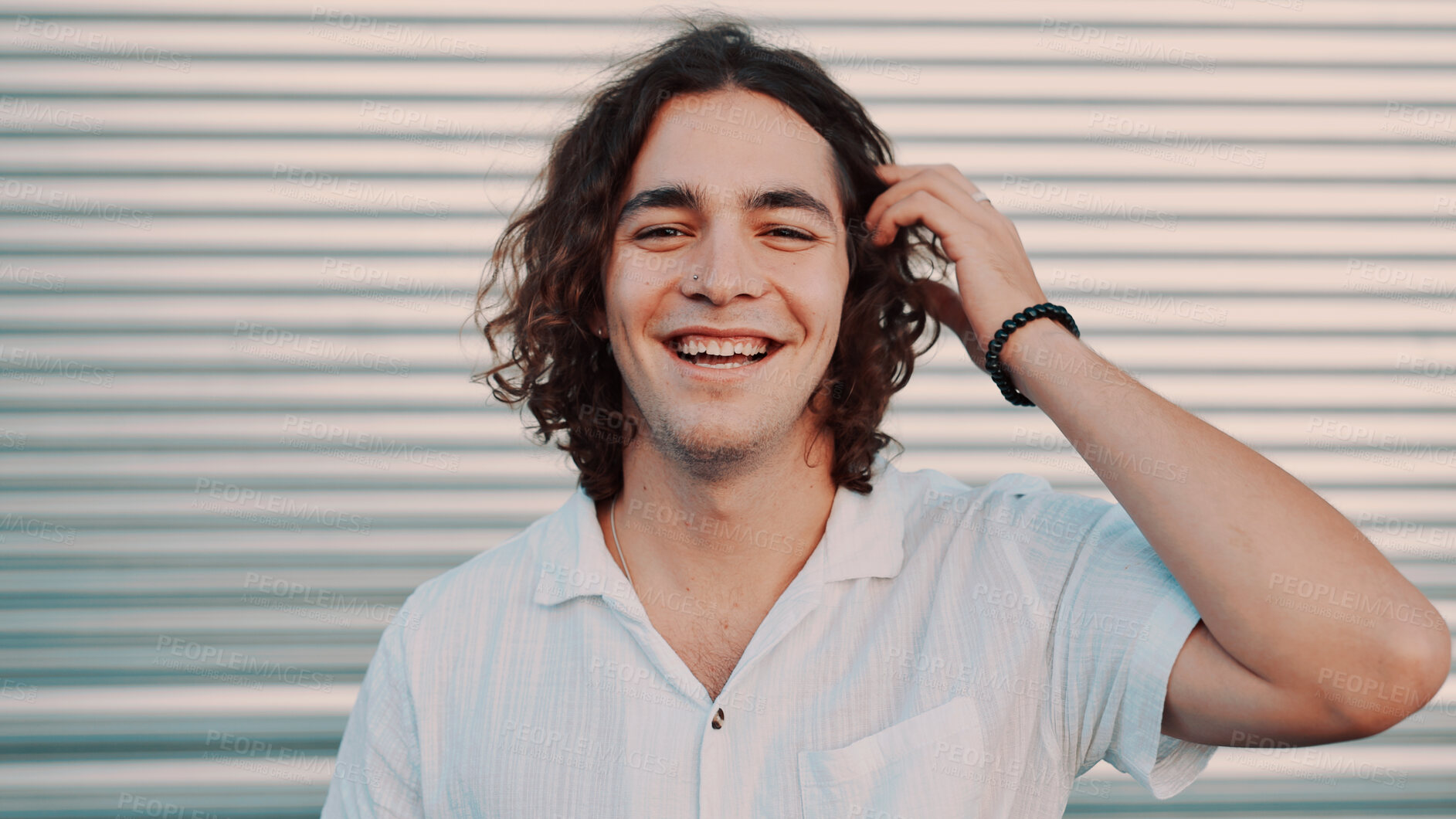 Buy stock photo Portrait, laugh and man in city for travel, vacation and adventure by garage door. Hair, funny and person outdoor with confidence on holiday, tourism and space on trip with happiness in Argentina
