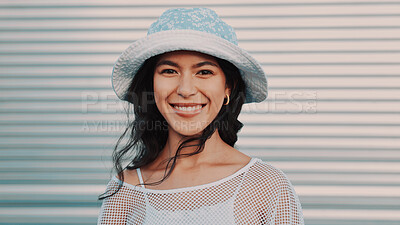 Buy stock photo Portrait, smile and woman in city for fashion, style and urban clothes with space by garage door. Hat, happiness and person outdoor with confidence, trendy and gen z streetwear with wind in Argentina