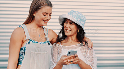 Buy stock photo People, friends and hug with phone outdoor for social media, reading meme and holiday reunion. Happy, women and embrace with mobile for browsing website, online gossip and bonding for getaway hangout